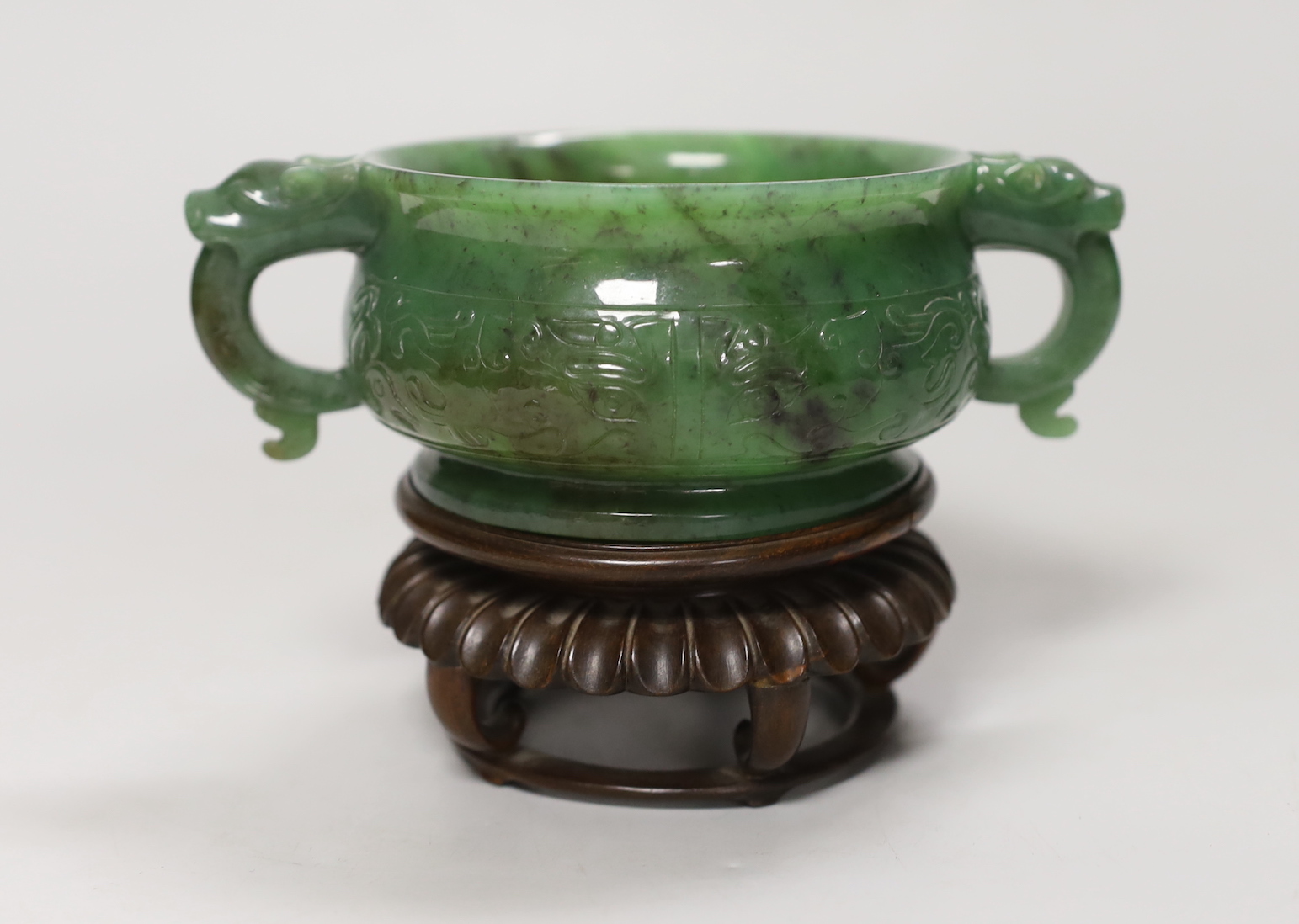 A Chinese archaistic green jade censer, wood stand. 10cm tall incl. stand